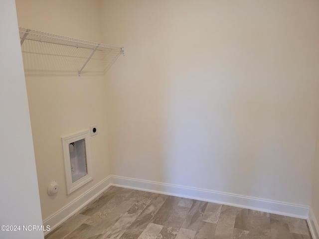 laundry area featuring electric dryer hookup and baseboards