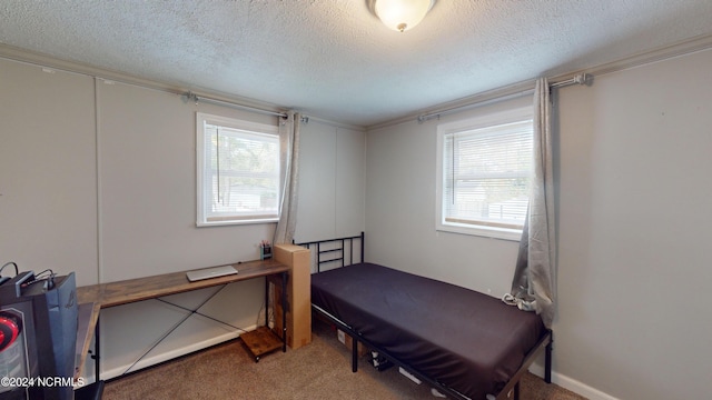 bedroom featuring a textured ceiling and carpet floors