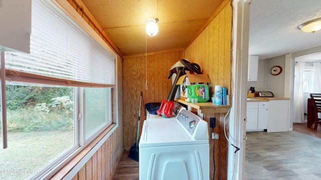 washroom with independent washer and dryer and wood walls