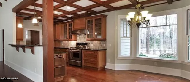 kitchen with ventilation hood, stainless steel gas range oven, hanging light fixtures, and coffered ceiling