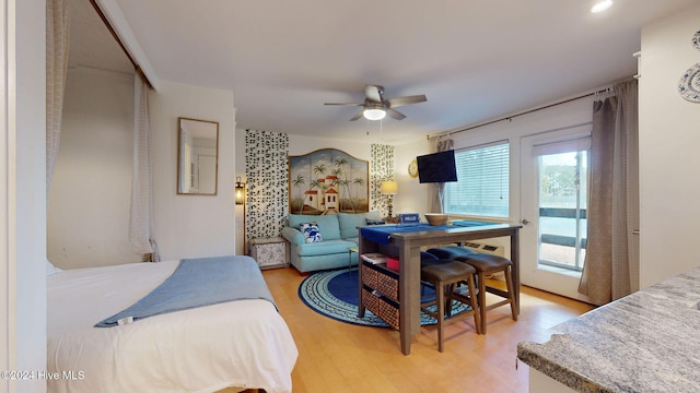 bedroom with hardwood / wood-style flooring and ceiling fan