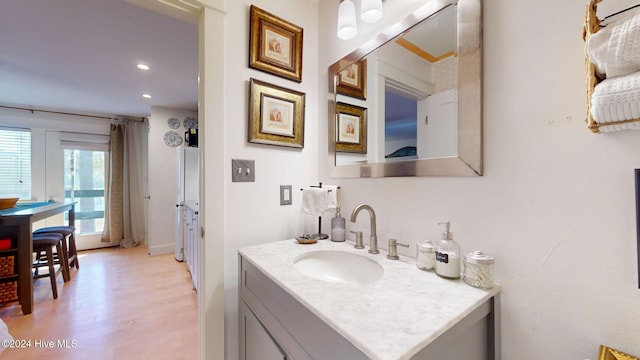 bathroom with hardwood / wood-style floors and vanity