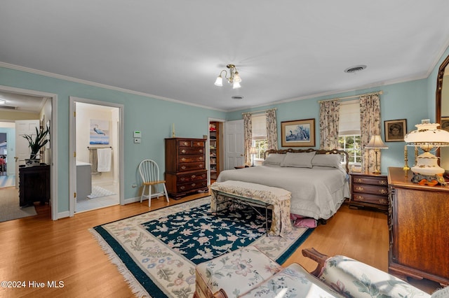 bedroom with ensuite bath, crown molding, and light wood-type flooring