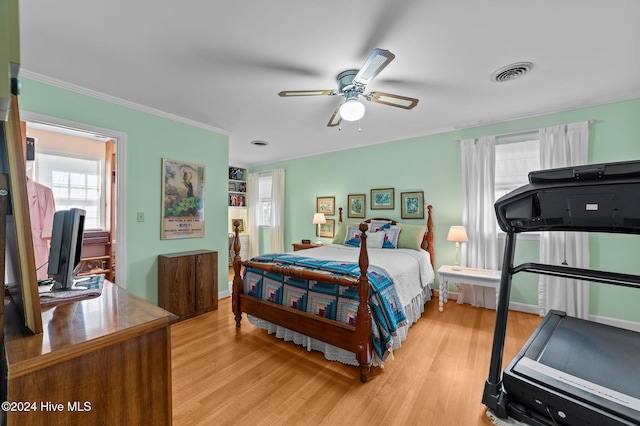 bedroom with ornamental molding, light wood-type flooring, and ceiling fan