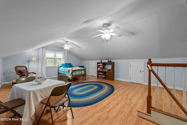 bedroom with vaulted ceiling, light wood-type flooring, and ceiling fan