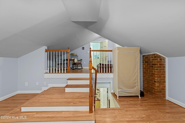 bonus room with lofted ceiling and wood-type flooring