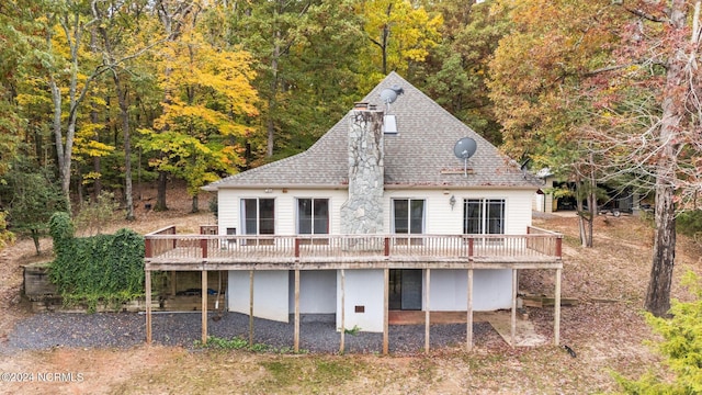 rear view of house featuring a wooden deck