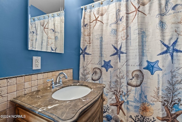 bathroom with vanity and tasteful backsplash