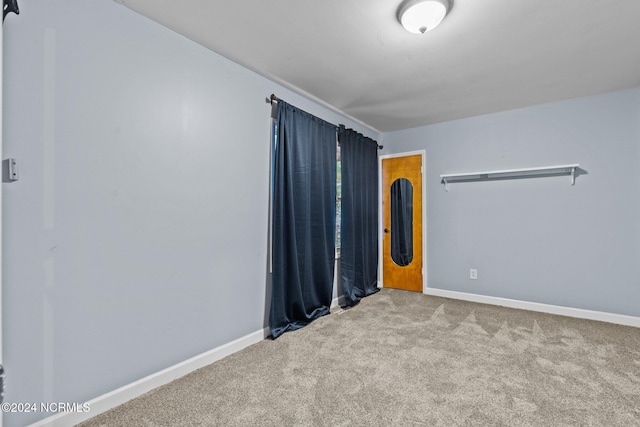 unfurnished room with light carpet