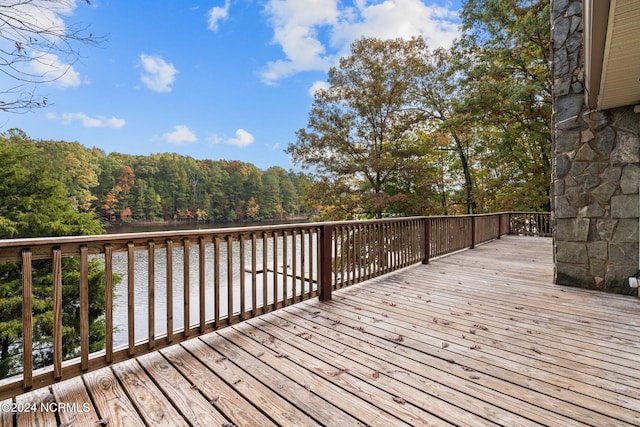 wooden terrace featuring a water view