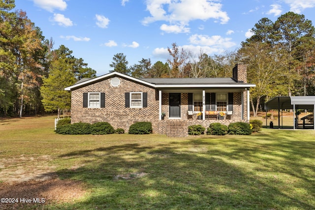 view of front facade with a porch, a carport, and a front lawn