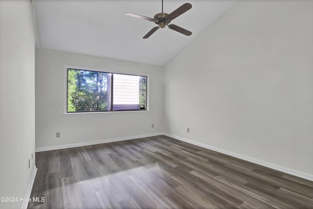 spare room with lofted ceiling, dark wood-type flooring, and ceiling fan