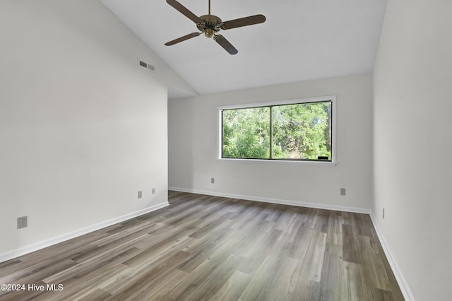 spare room with vaulted ceiling, ceiling fan, and light hardwood / wood-style flooring