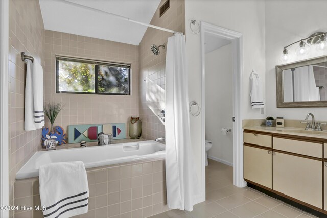 full bathroom with vaulted ceiling, tile patterned flooring, vanity, toilet, and shower / bath combo