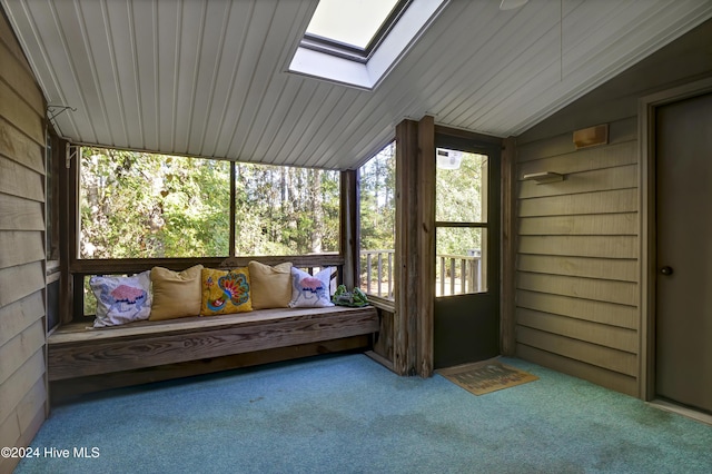 unfurnished sunroom featuring lofted ceiling with skylight