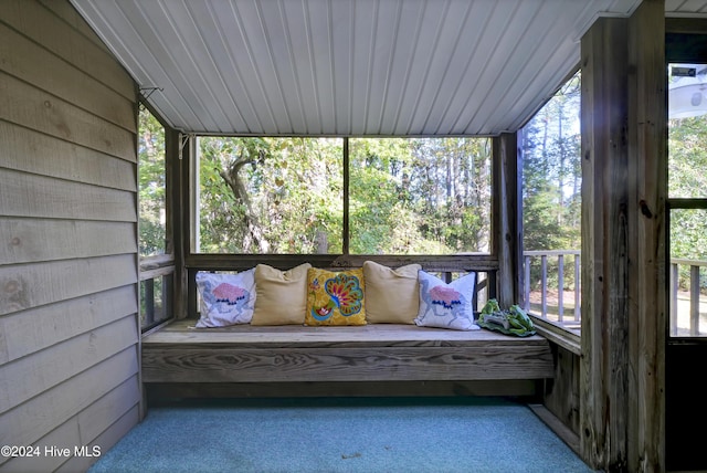 unfurnished sunroom with wood ceiling