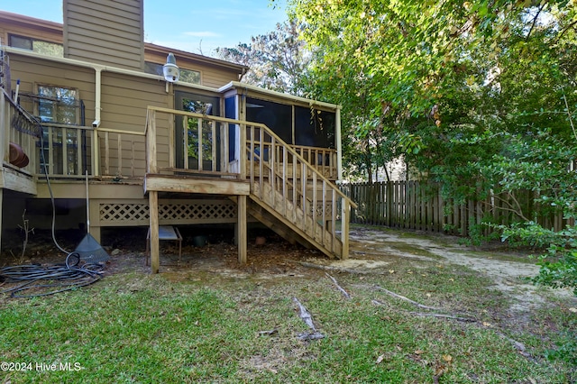 back of property featuring a sunroom and a deck