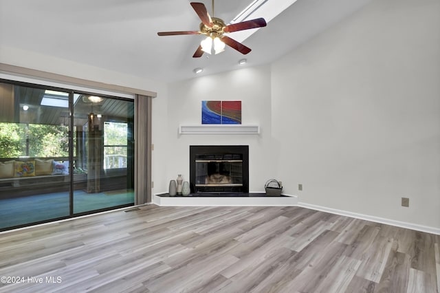 unfurnished living room with ceiling fan, lofted ceiling, and light hardwood / wood-style floors