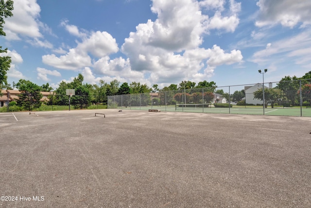 view of home's community with tennis court