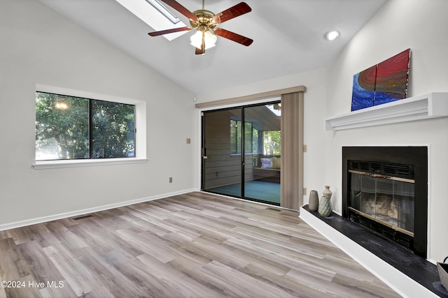 unfurnished living room featuring high vaulted ceiling, ceiling fan, and light wood-type flooring