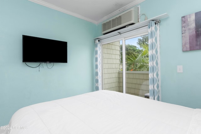 bedroom with crown molding and a wall mounted air conditioner