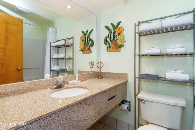 bathroom featuring vanity, toilet, tile patterned flooring, and a shower with shower curtain