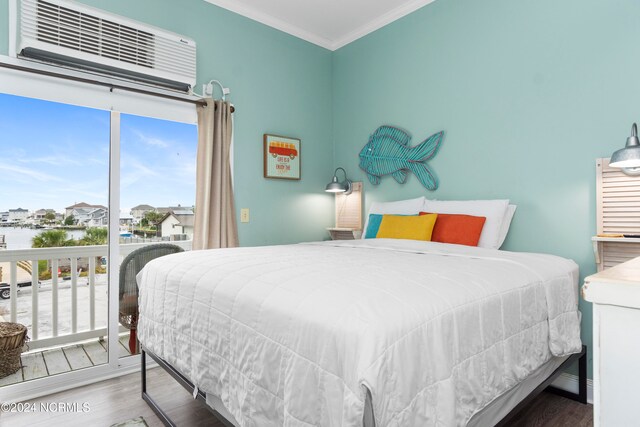 bedroom featuring ornamental molding, hardwood / wood-style floors, and a wall mounted AC