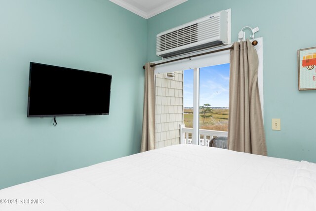 bedroom featuring crown molding and a wall mounted air conditioner