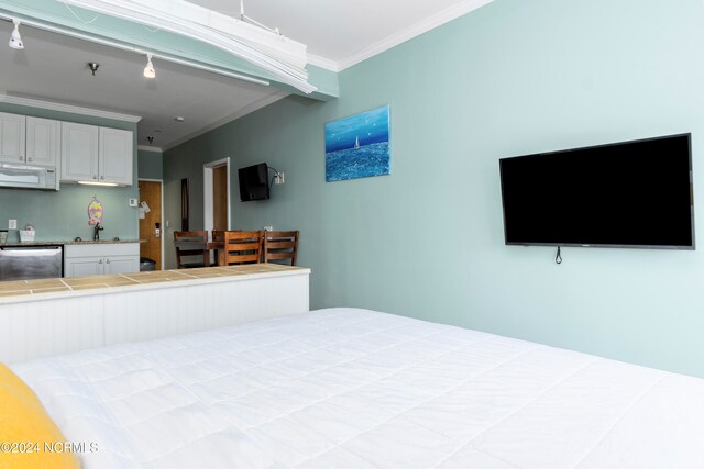 bedroom featuring ornamental molding and sink