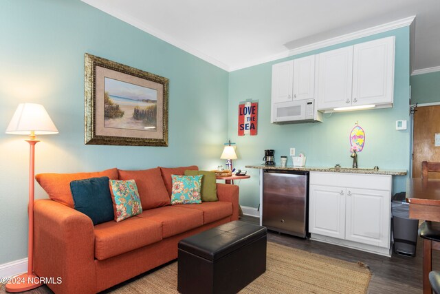 living room featuring crown molding, sink, and wood-type flooring