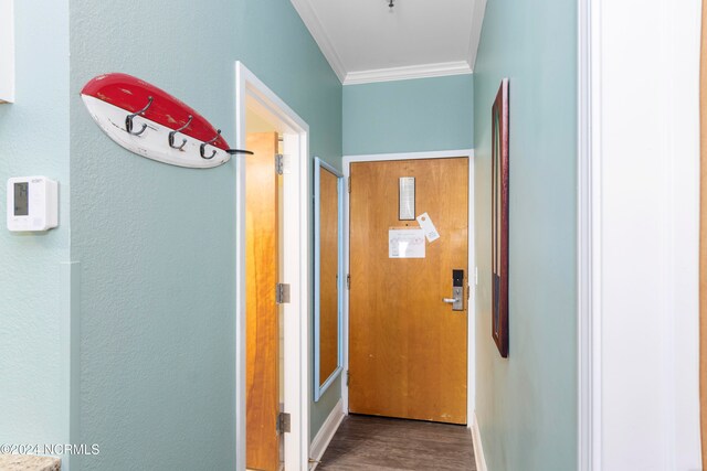 hallway with ornamental molding and hardwood / wood-style flooring