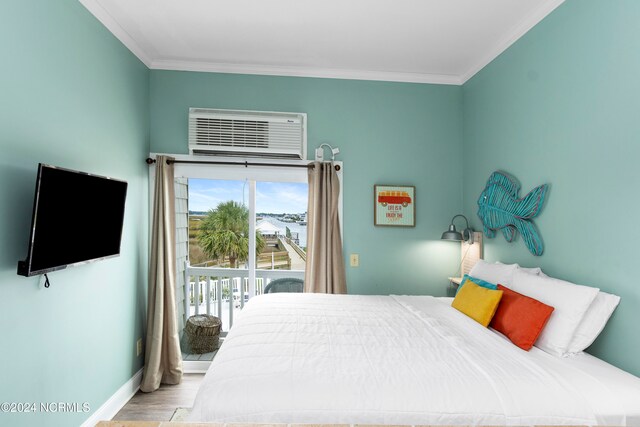 bedroom featuring crown molding, a wall mounted air conditioner, access to exterior, and light hardwood / wood-style floors