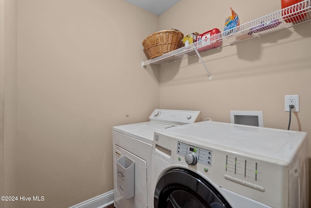 clothes washing area with independent washer and dryer