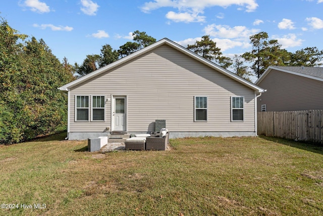 rear view of house with a lawn