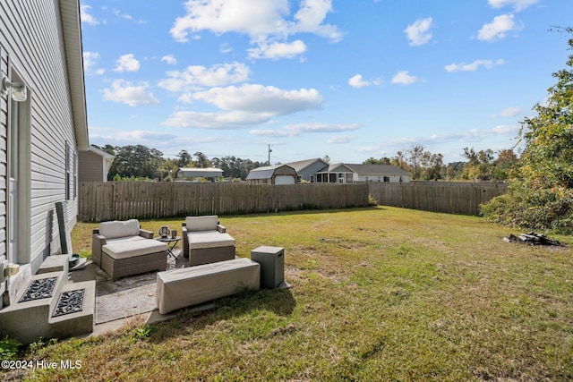 view of yard with outdoor lounge area and a patio