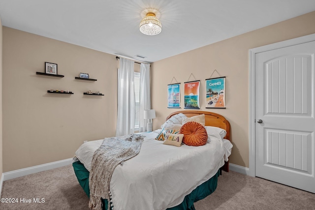 bedroom featuring light colored carpet