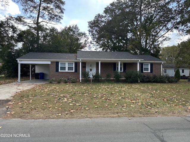 ranch-style house with a carport and a front yard