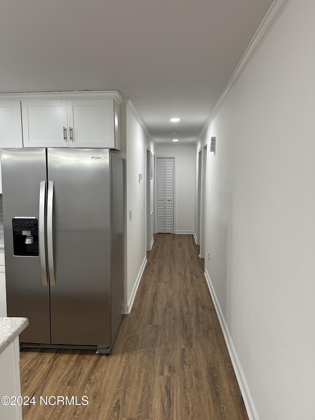 hallway featuring ornamental molding and dark hardwood / wood-style floors