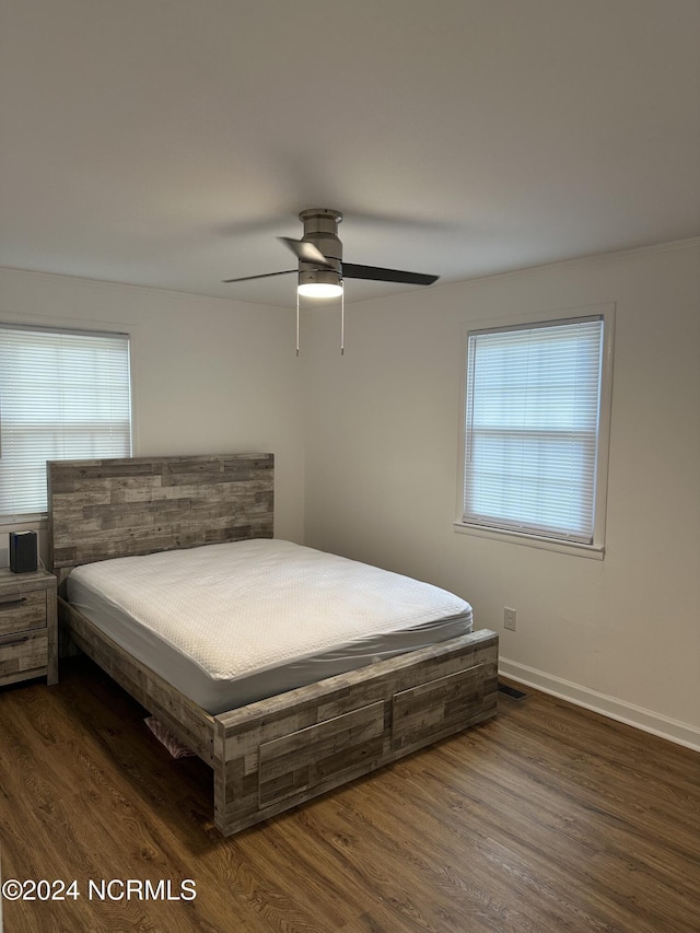 bedroom with ceiling fan and dark hardwood / wood-style floors