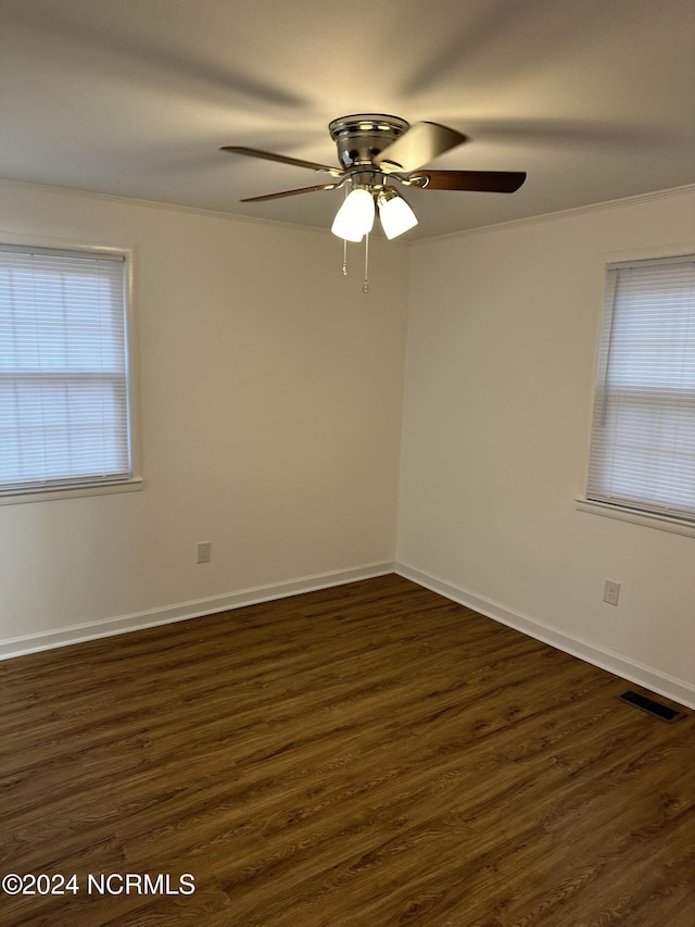 unfurnished room featuring dark hardwood / wood-style flooring, crown molding, and ceiling fan