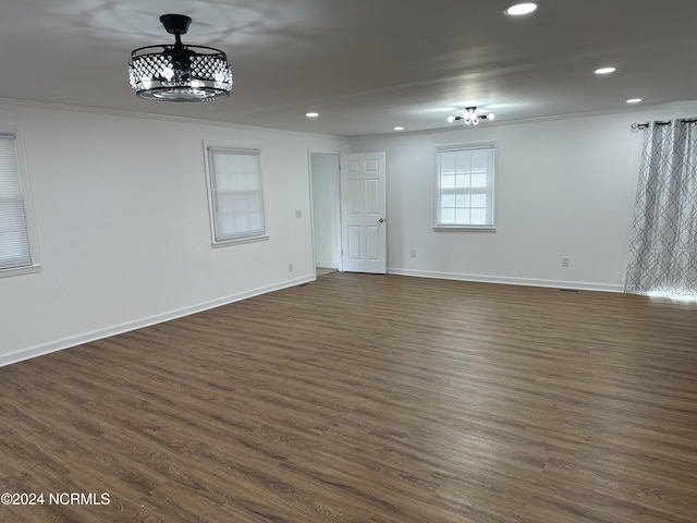 spare room featuring crown molding and dark hardwood / wood-style flooring