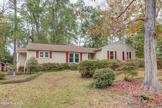 ranch-style home with a front lawn