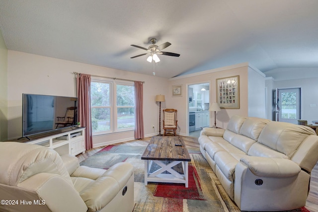 living room featuring ceiling fan, a healthy amount of sunlight, lofted ceiling, and wood-type flooring