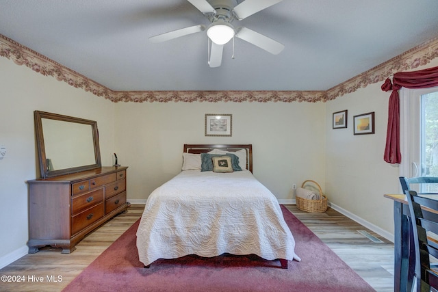 bedroom with ceiling fan and light wood-type flooring