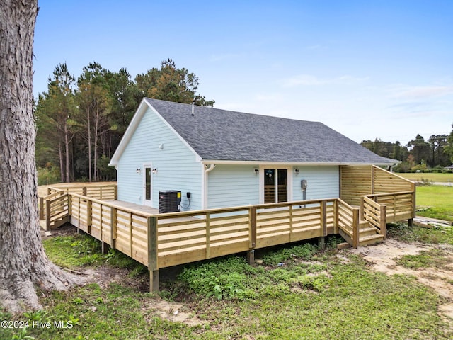 rear view of house with central AC and a wooden deck