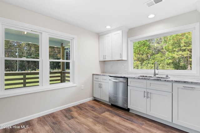 kitchen with dishwasher, dark wood-type flooring, white cabinets, sink, and light stone counters