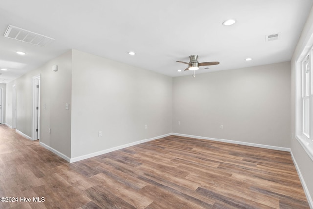 empty room with hardwood / wood-style floors and ceiling fan