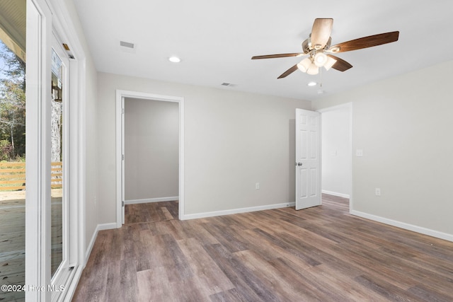 spare room featuring hardwood / wood-style flooring and ceiling fan