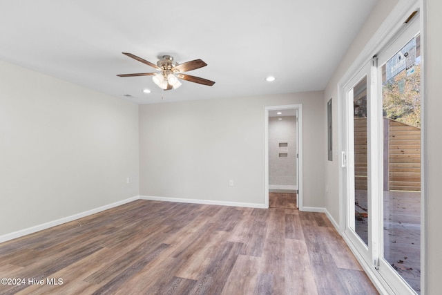 spare room featuring hardwood / wood-style flooring and ceiling fan