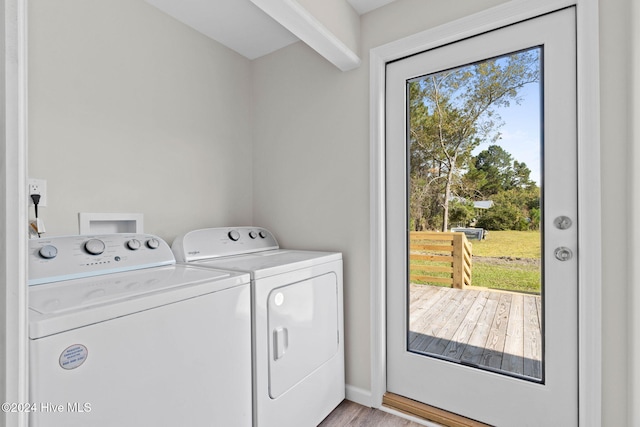 washroom with light hardwood / wood-style floors and washing machine and clothes dryer